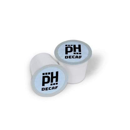 Two white coffee pods with 'PH Decaf' text on a white background